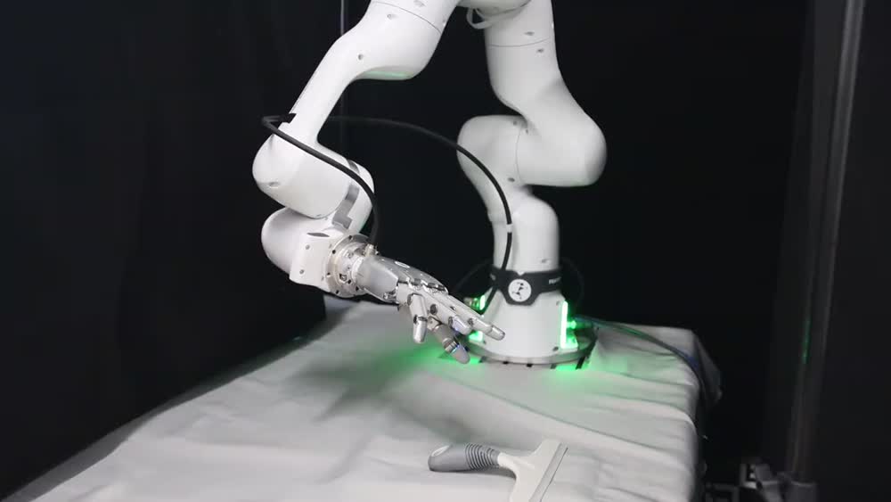 Real robot · cleaning a table with a squeegee